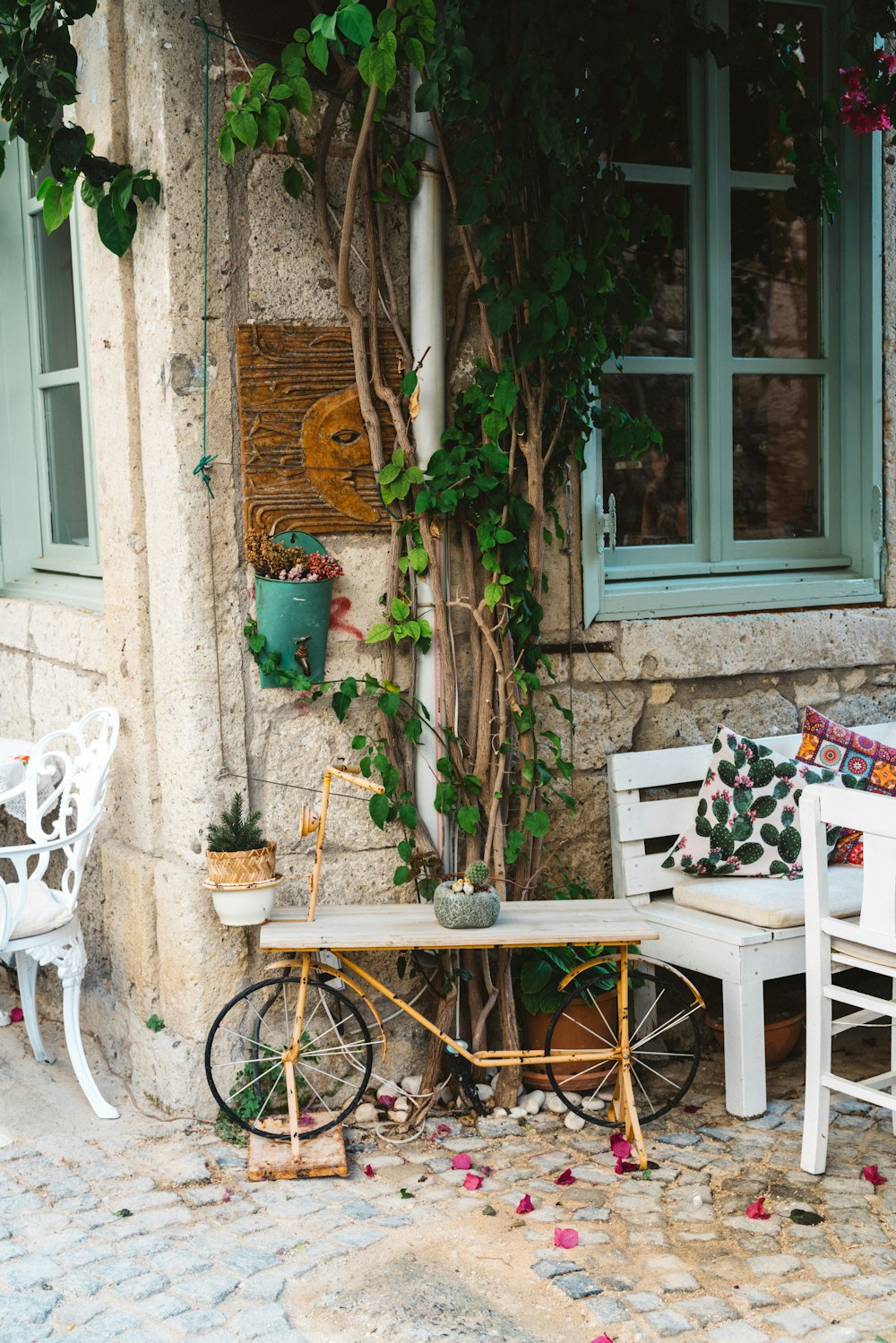 a white bench sitting next to a white table