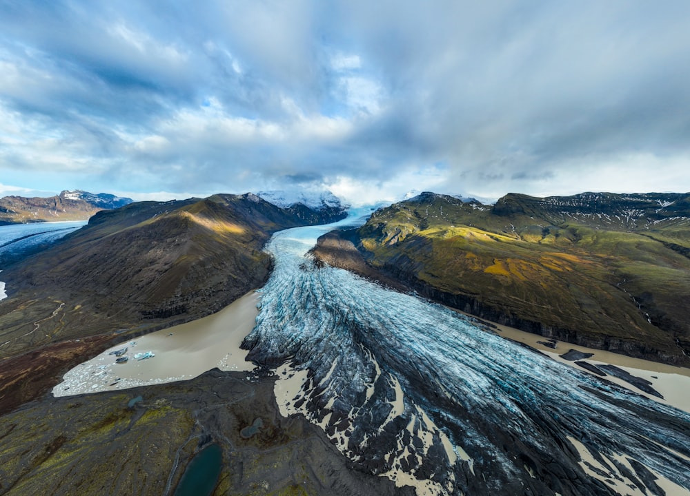 an aerial view of a river and mountains