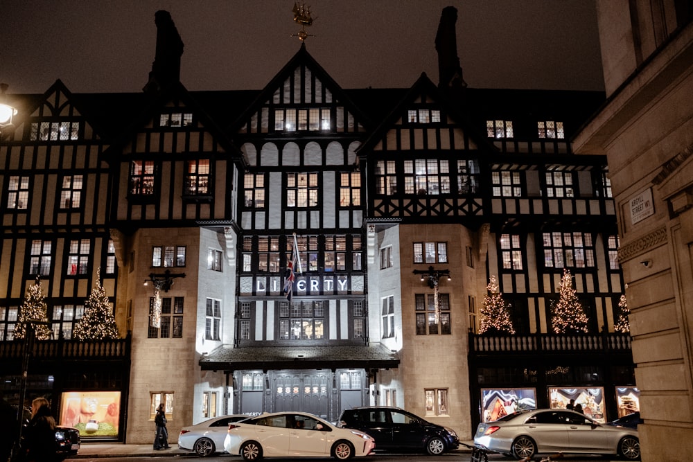 cars parked in front of a building at night