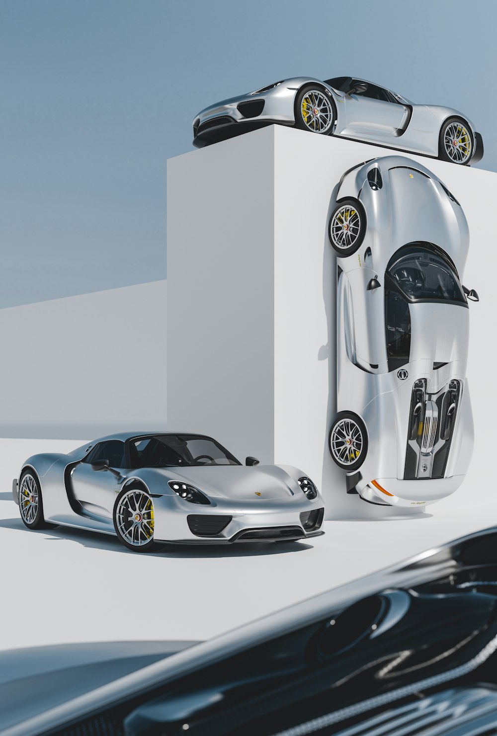 a silver sports car parked next to a white box