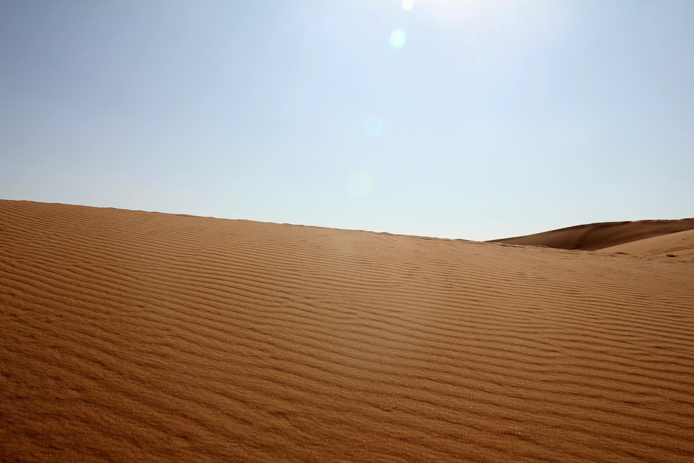 the sun is shining over a sandy area