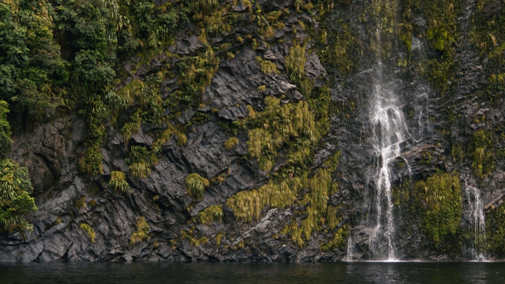 a waterfall with a boat in front of it