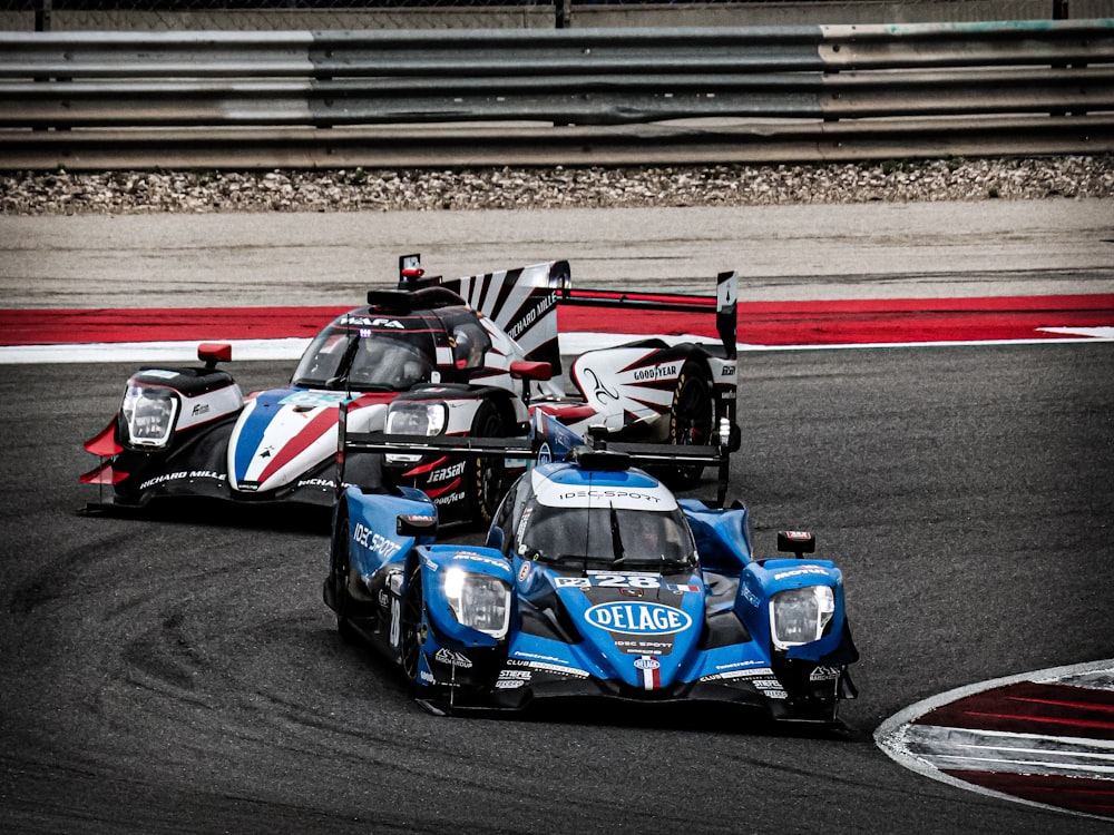 two racing cars driving on a race track