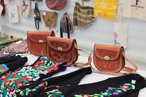a group of purses sitting on top of a table