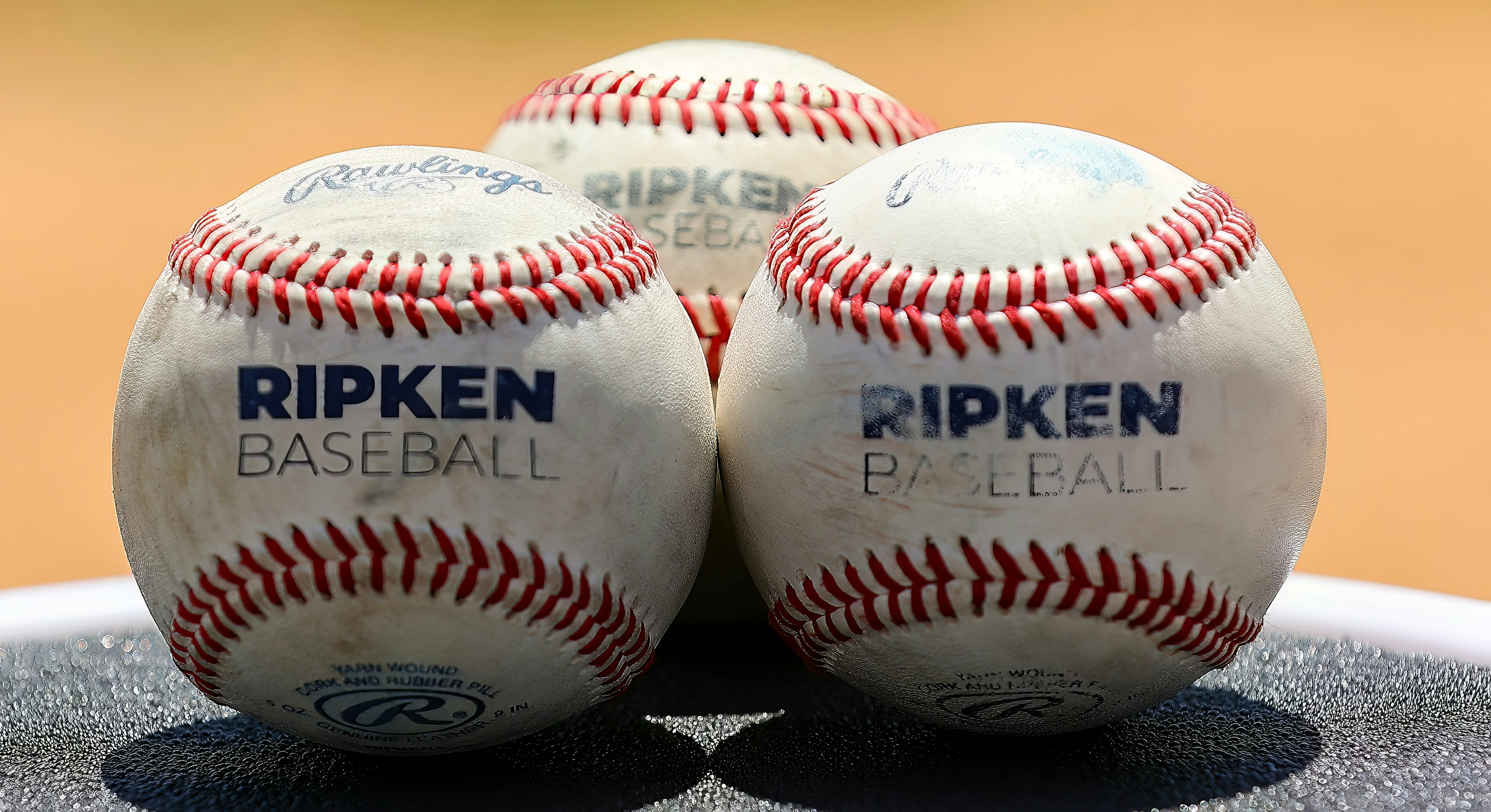 three baseballs sitting on top of a table