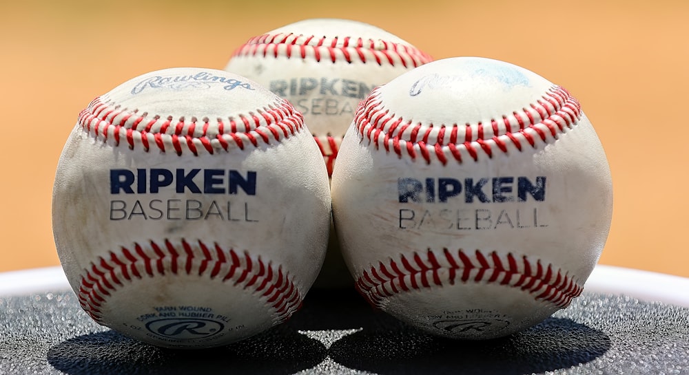 three baseballs sitting on top of a table