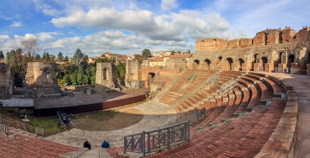 an old amphit with a few people walking around it