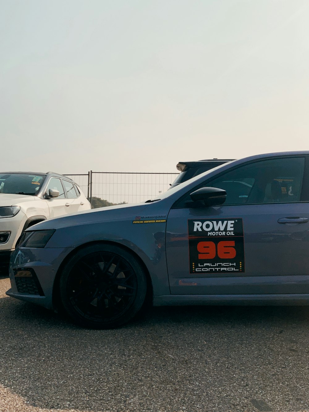a silver car with a rowe sign on the side of it