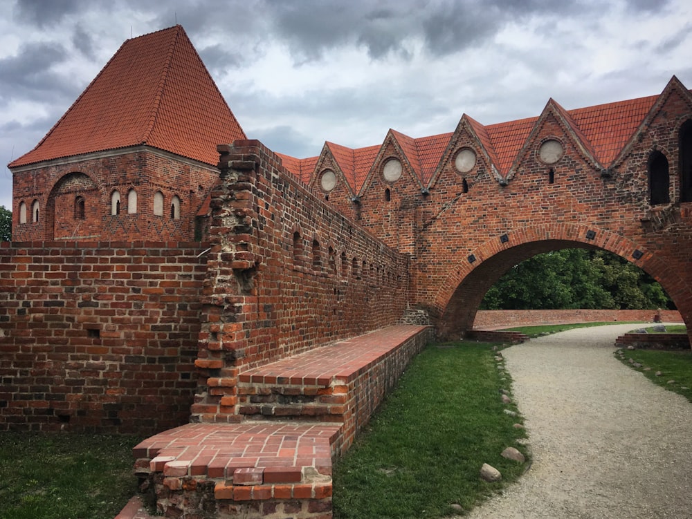 an old brick building with a walkway leading to it