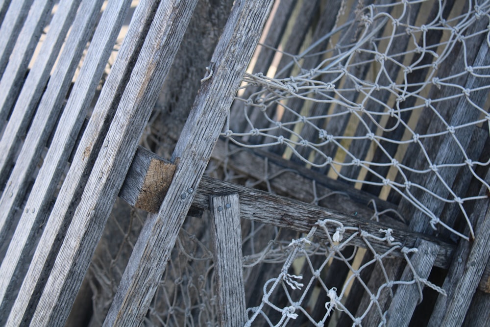 a close up of a wooden fence with a net on top of it