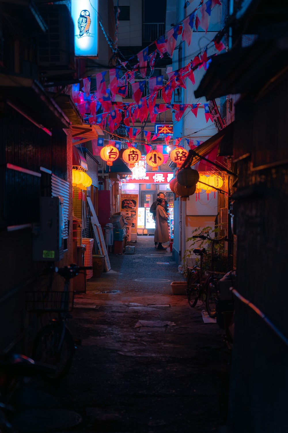 a narrow alley way with a person standing in the doorway