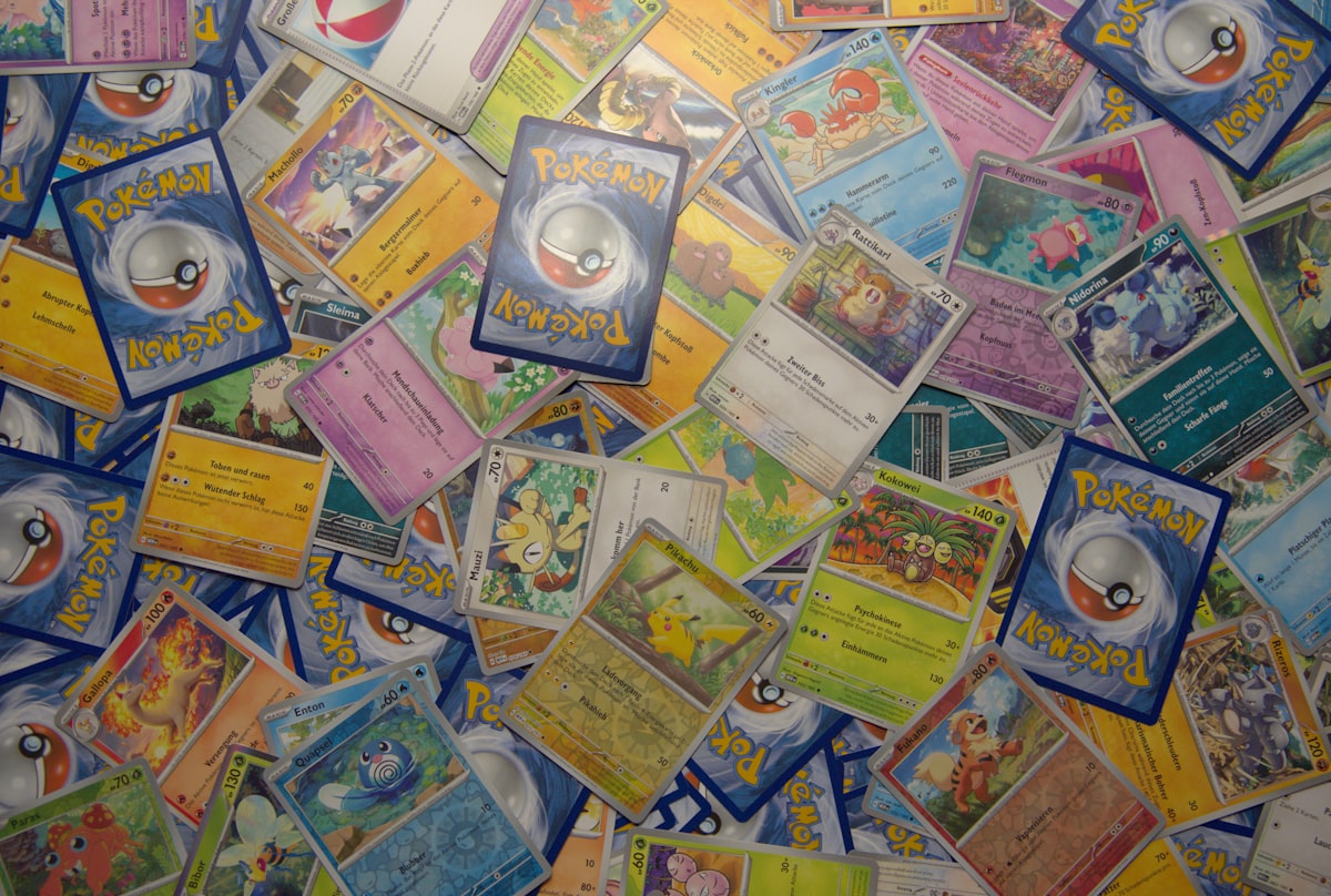 Bunch of Pokemon TCG cards spread across collector workspace showing the gear ecosystem that surrounds an active collection