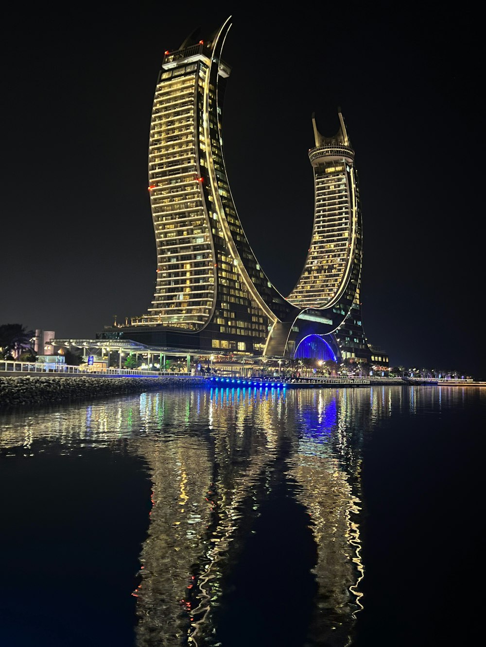 a very tall building sitting on top of a body of water