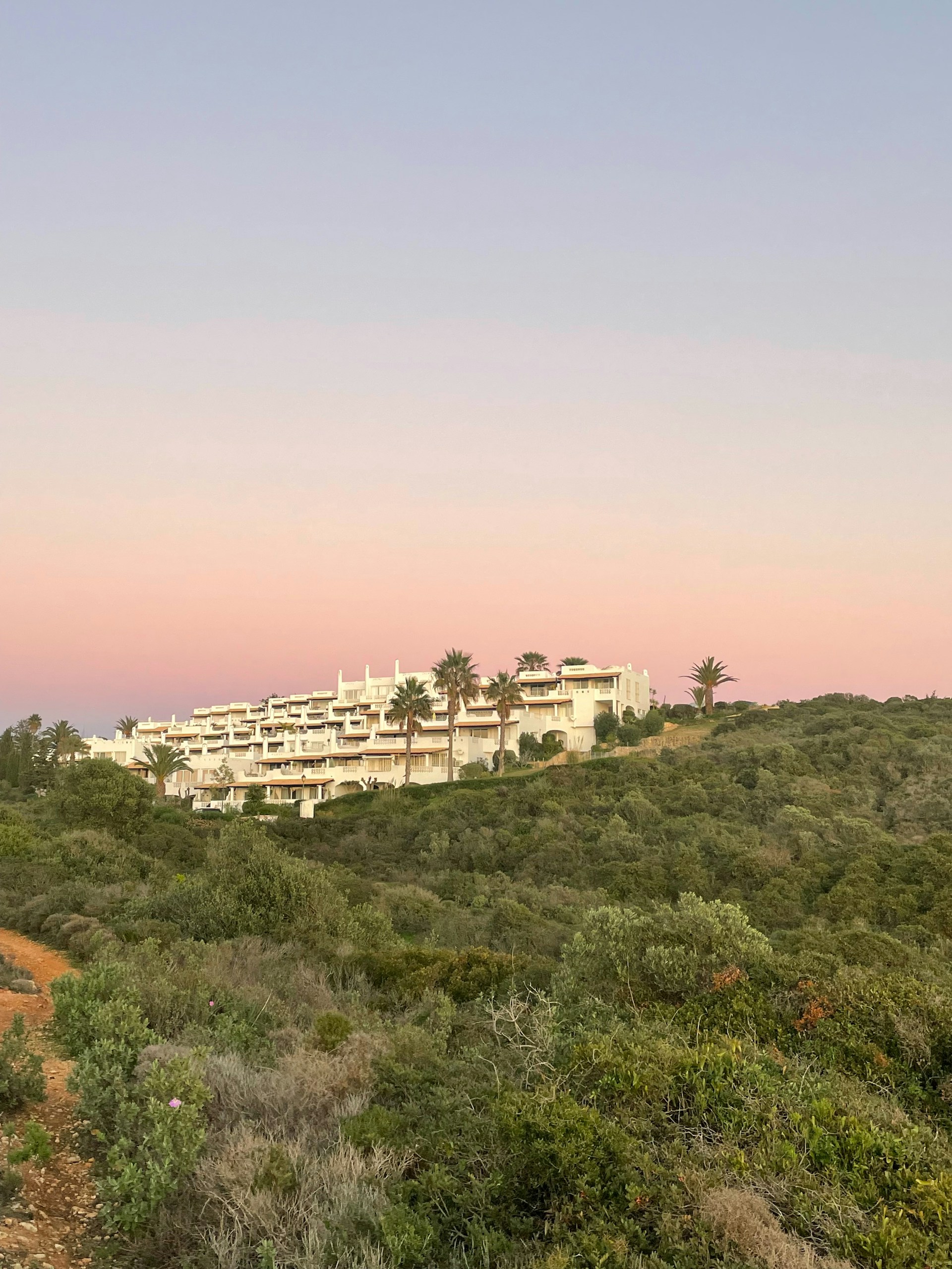 woman wearing yellow long-sleeved dress under white clouds and blue sky during daytime
