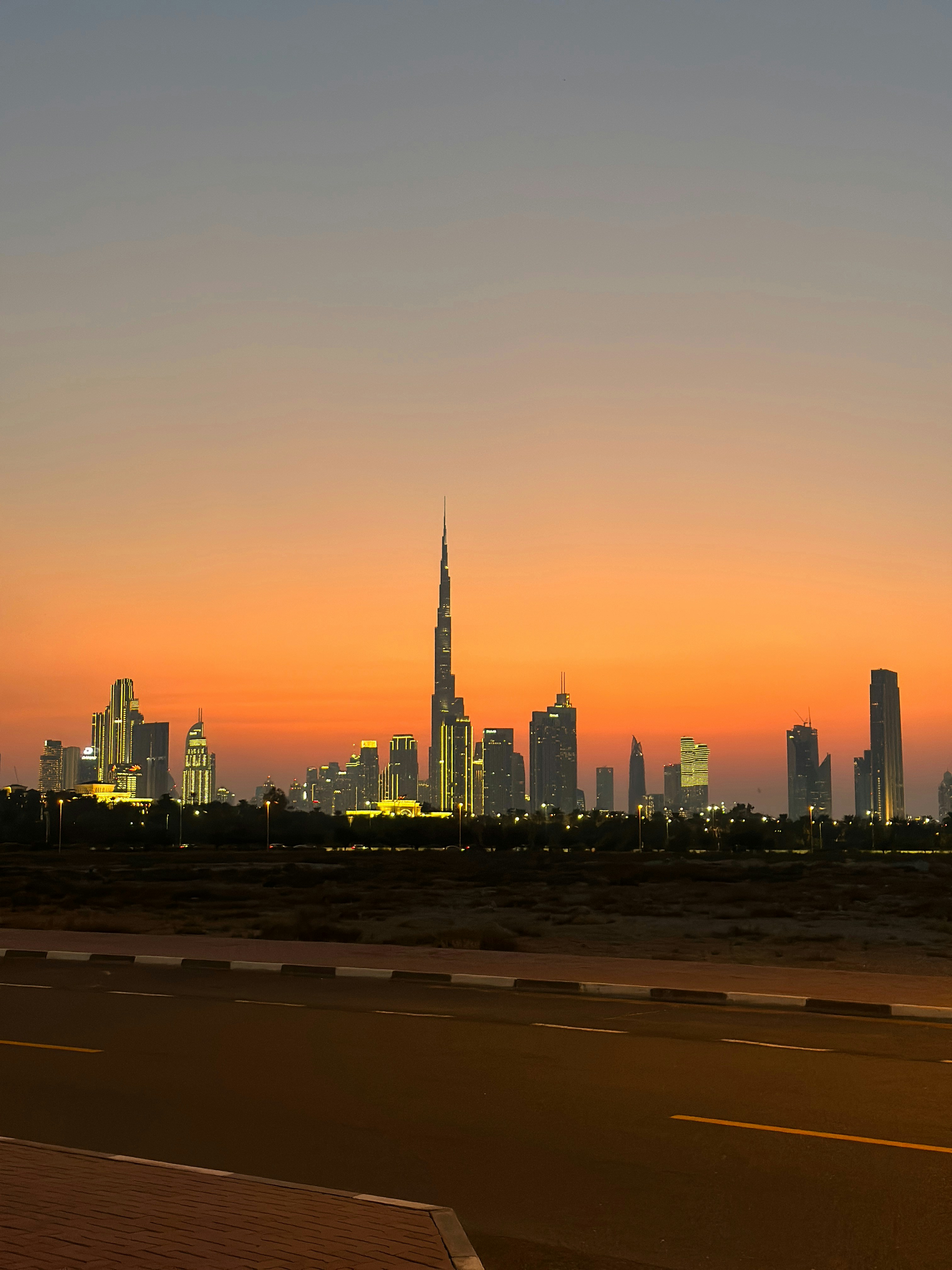 Dubai skyline at blue hour with illuminated skyscrapers against deep dark twilight sky