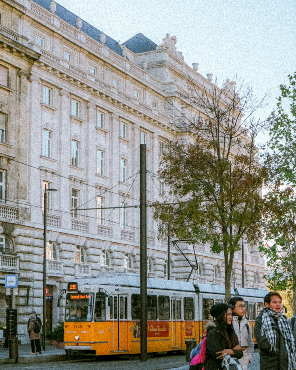 a group of people standing on the side of a road