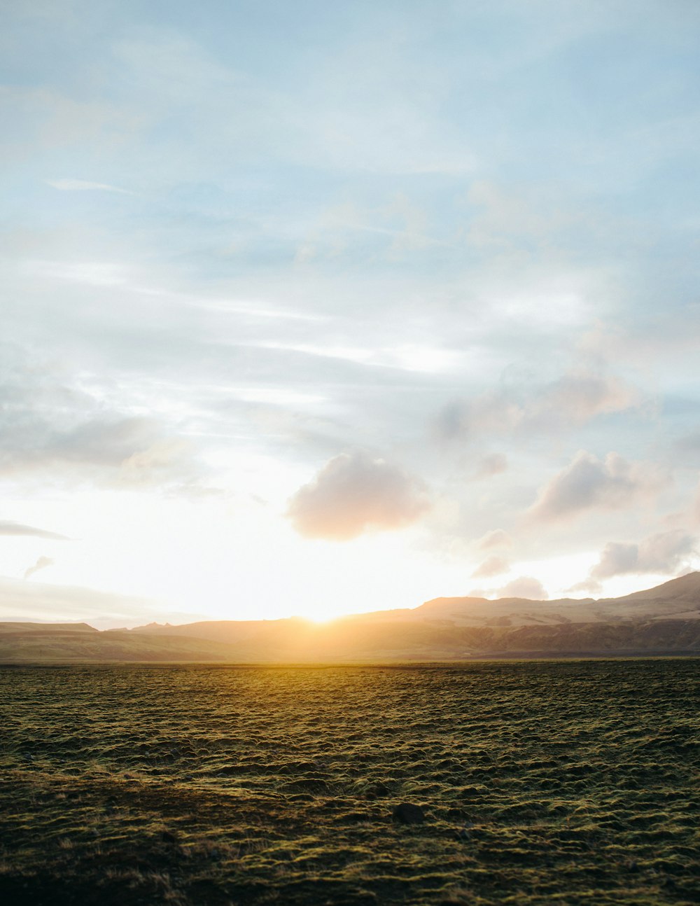 the sun is setting over a large body of water