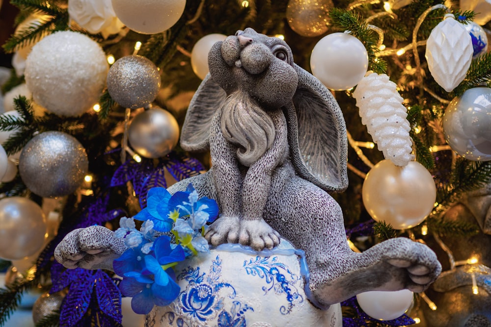 a statue of an elephant sitting on top of a vase