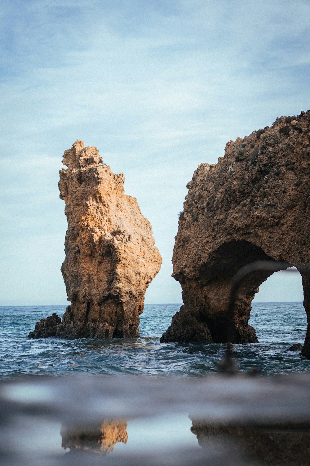 two large rocks sticking out of the ocean