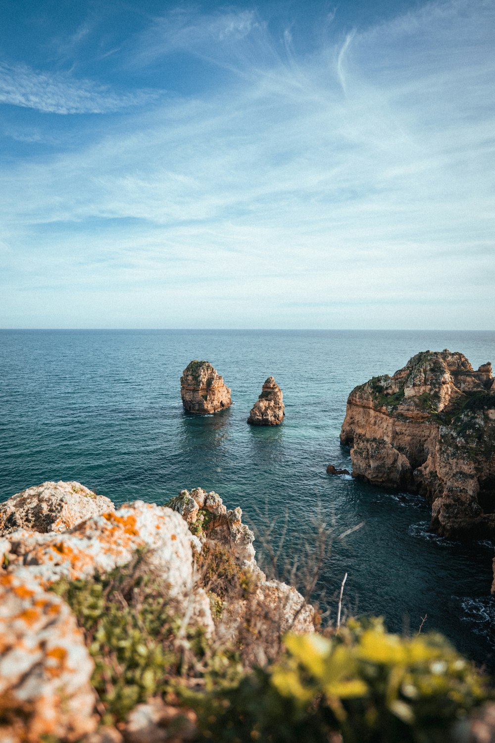 a couple of rocks sitting on top of a body of water