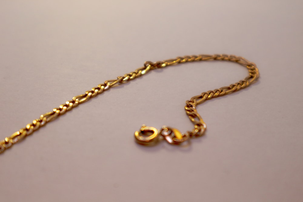 a close up of a gold chain on a table