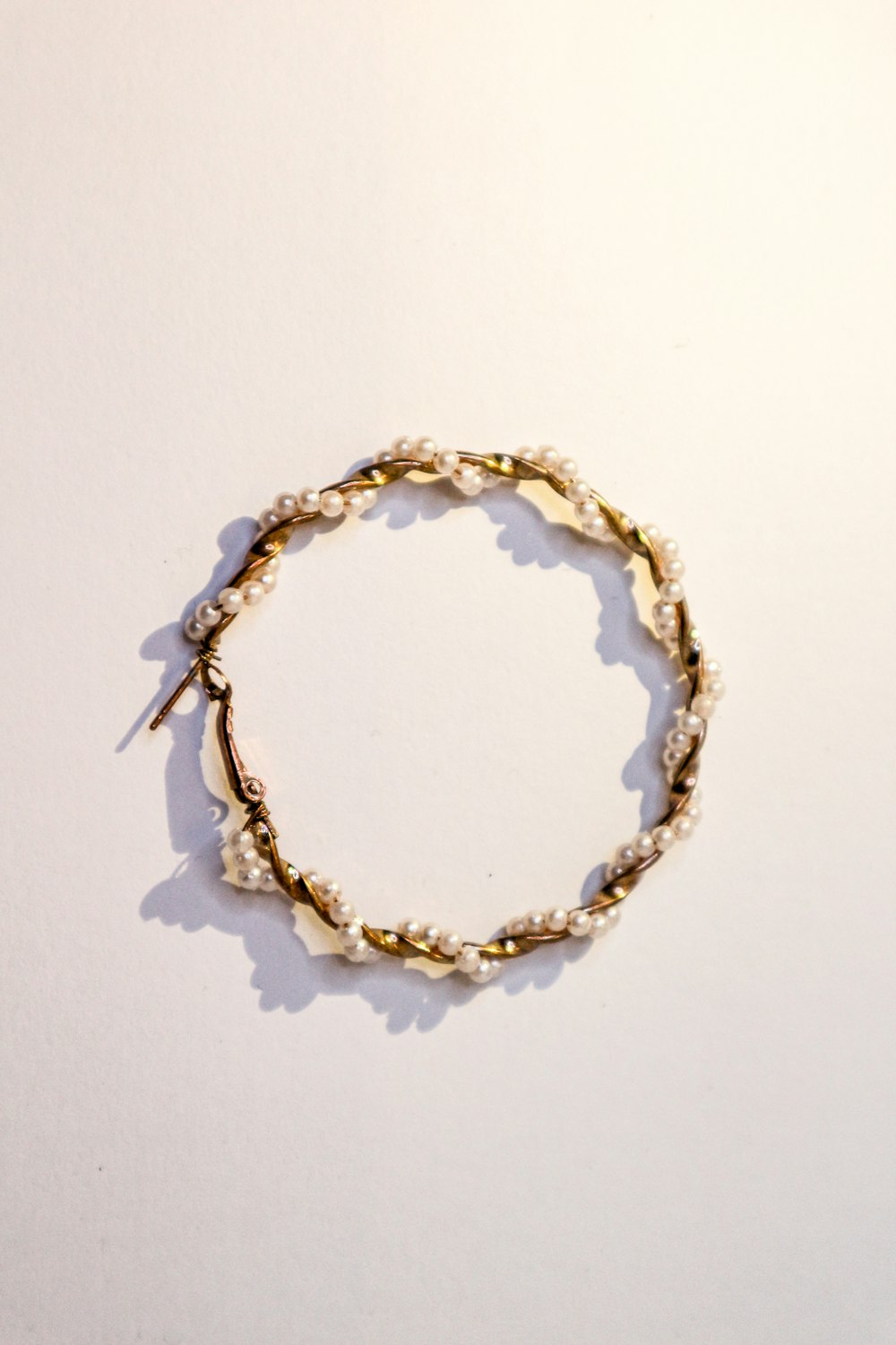 a close up of a bracelet on a white surface