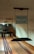 A vintage bowling alley with wooden lanes and a sign hanging that reads 'Observe the Foul Line'. The lanes are polished and lead towards a set of bowling pins in the distance. The lighting is dim, giving the scene a nostalgic feel.