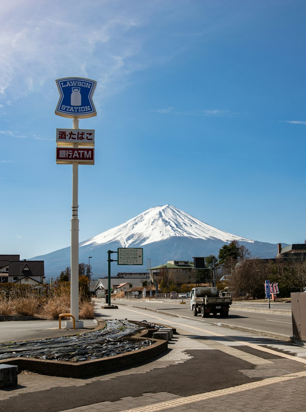 a street sign with a mountain in the background