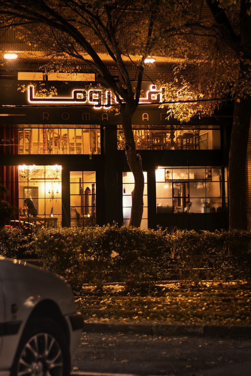 a car parked in front of a building at night