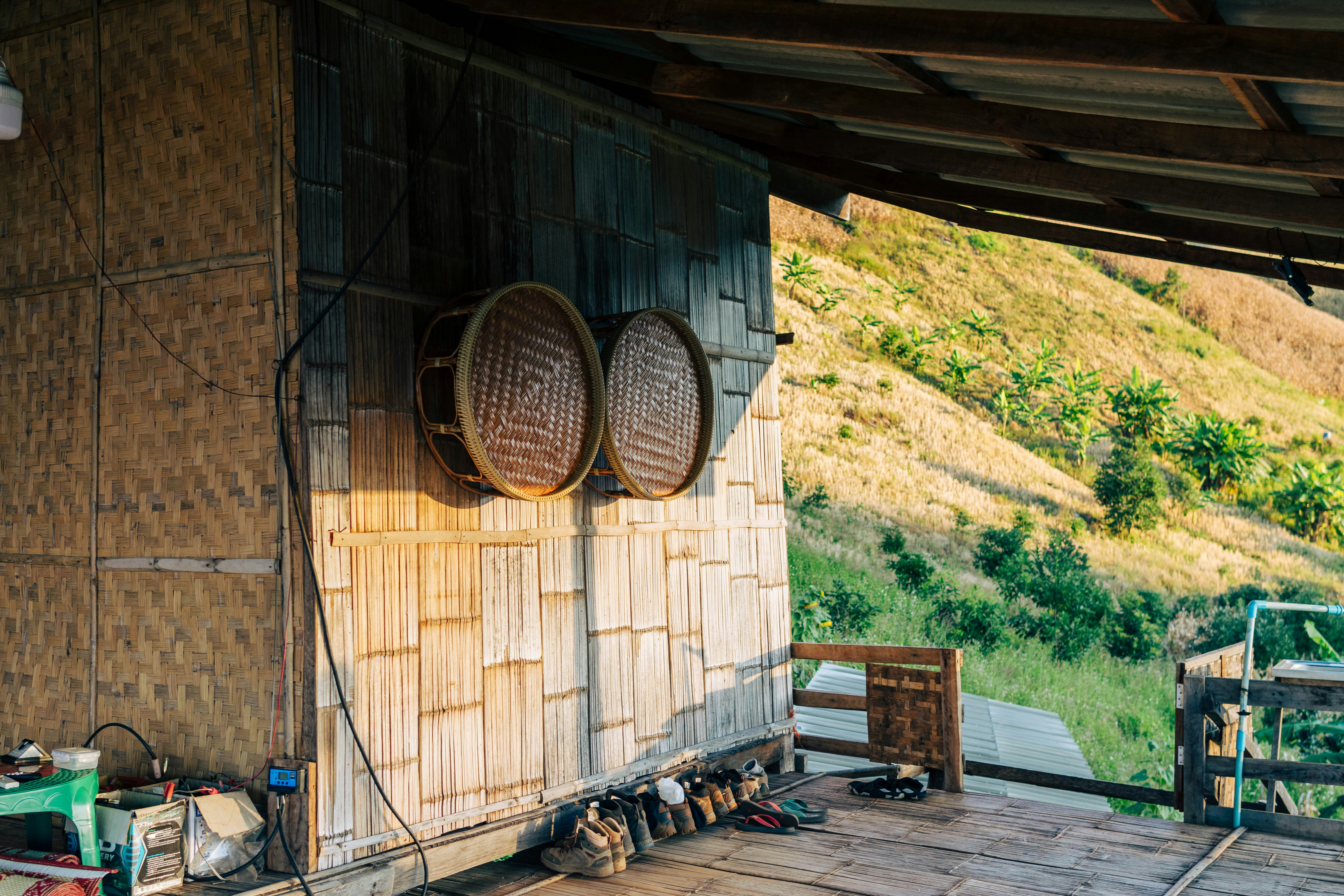 a view of a wooden building with two baskets on the wall