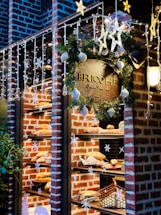 A cozy bakery storefront with warm lighting and fresh bread displayed in the window.