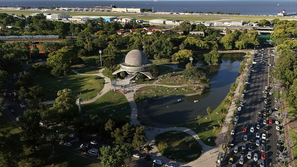 an aerial view of a park with cars parked in it