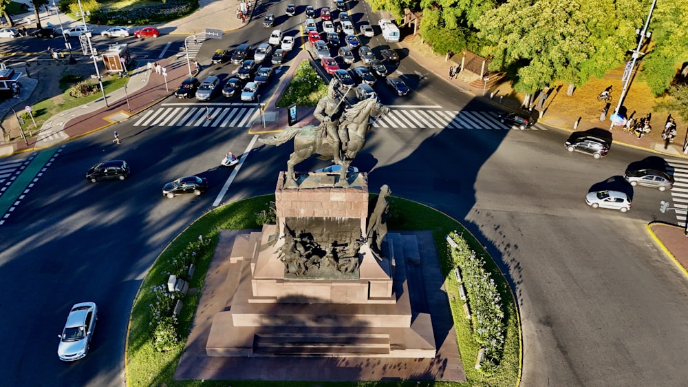 an aerial view of a city street with a statue