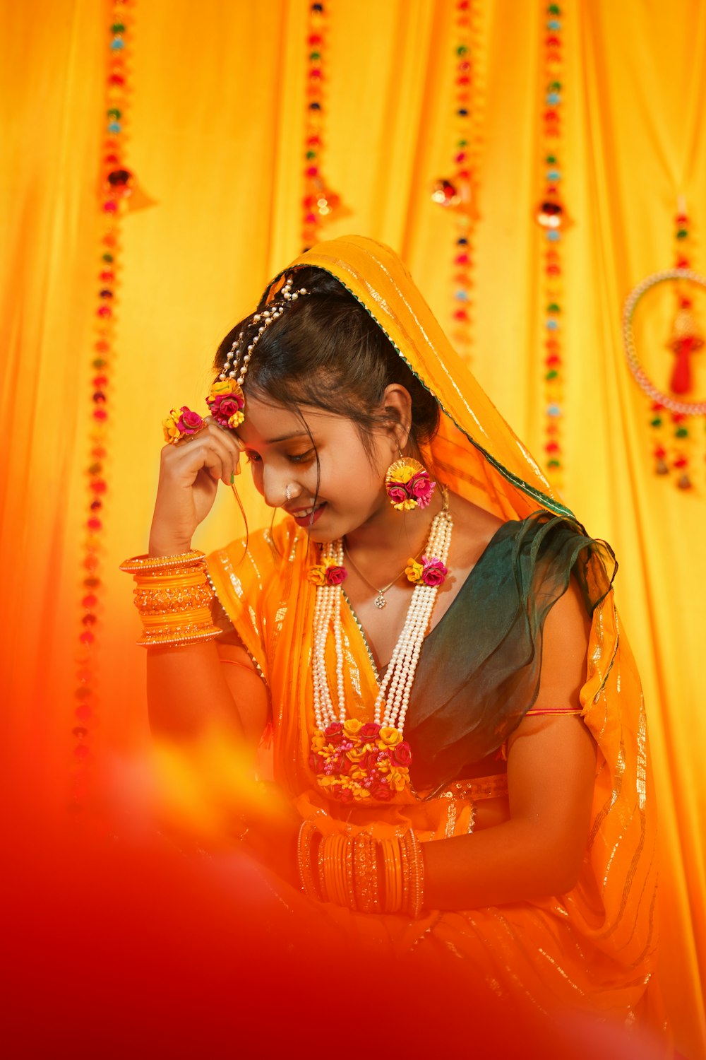a young girl dressed in a traditional indian costume
