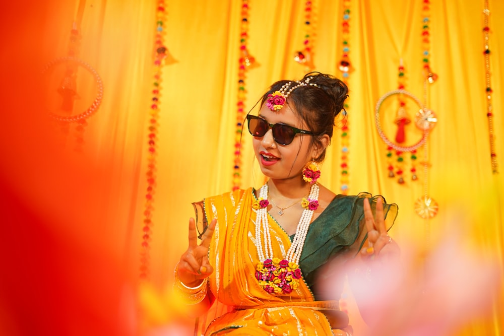 a woman in a yellow outfit and sunglasses