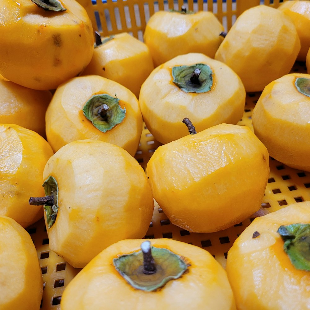 a basket filled with lots of yellow fruit