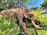 An elephant stands amidst lush greenery, its large tusks prominently visible. Two people are seated on the elephant's back, holding onto a chain for support. The surrounding foliage is dense, with a mix of green leaves and some flowering plants. In the background, part of a building with a red and white wall can be seen.