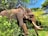 An elephant stands amidst lush greenery, its large tusks prominently visible. Two people are seated on the elephant's back, holding onto a chain for support. The surrounding foliage is dense, with a mix of green leaves and some flowering plants. In the background, part of a building with a red and white wall can be seen.
