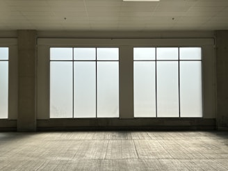 Bright office space with spotless floors and large glass windows.