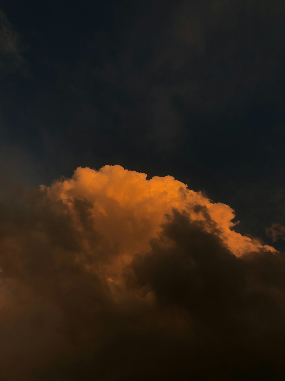 a plane flying through a cloudy sky at night