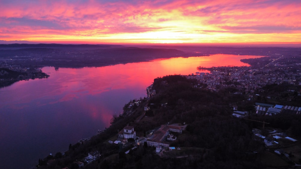 a beautiful sunset over a city and a body of water