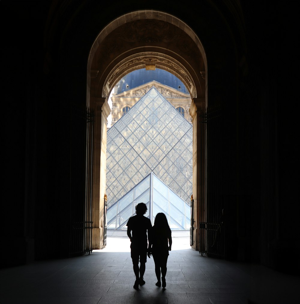 a couple of people that are standing in front of a building