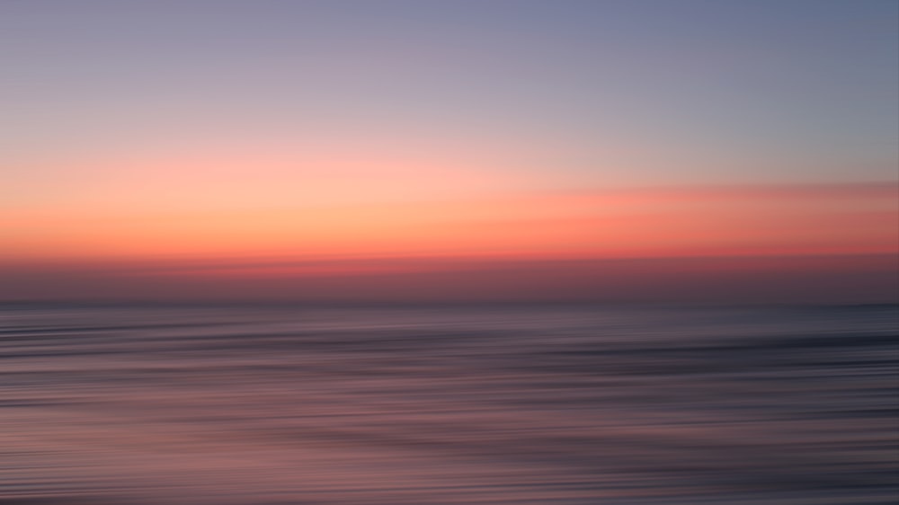 a blurry photo of a sunset over the ocean