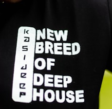 Text printed on a black fabric reads 'New Breed of Deep House' with the word 'Kasie' arranged vertically before it.