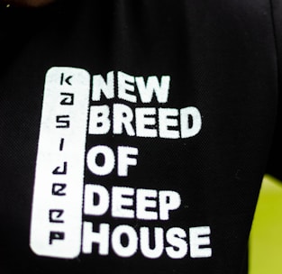 Text printed on a black fabric reads 'New Breed of Deep House' with the word 'Kasie' arranged vertically before it.