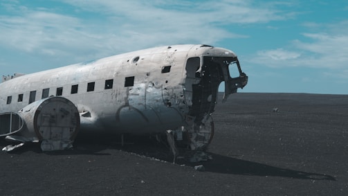 A wrecked aircraft resting in a salvage yard.