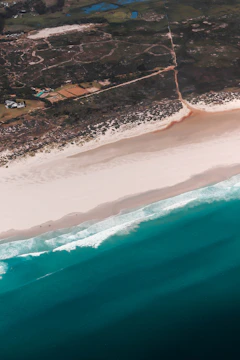 An aerial view of a coastline with a network graphic overlay symbolizing connections between influencers and brands.