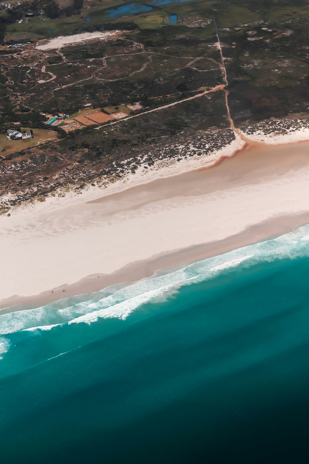 an aerial view of a beach and ocean