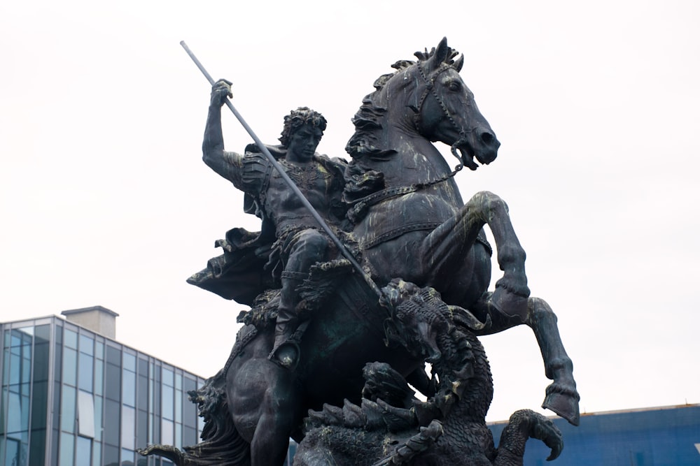 a statue of a man on a horse holding a spear