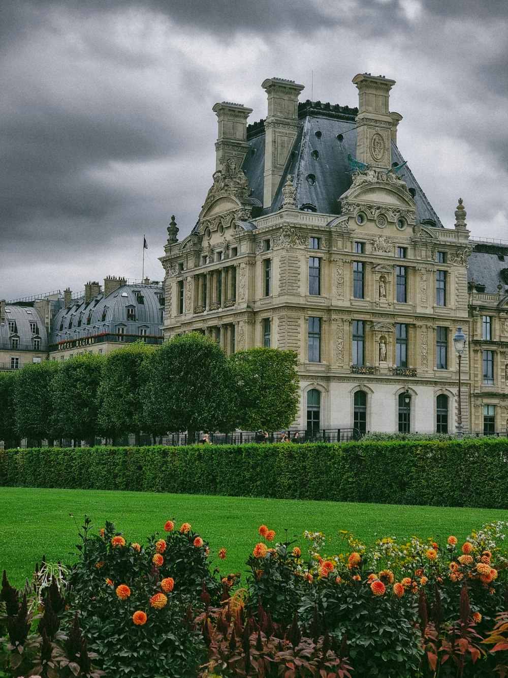 a large building sitting next to a lush green field